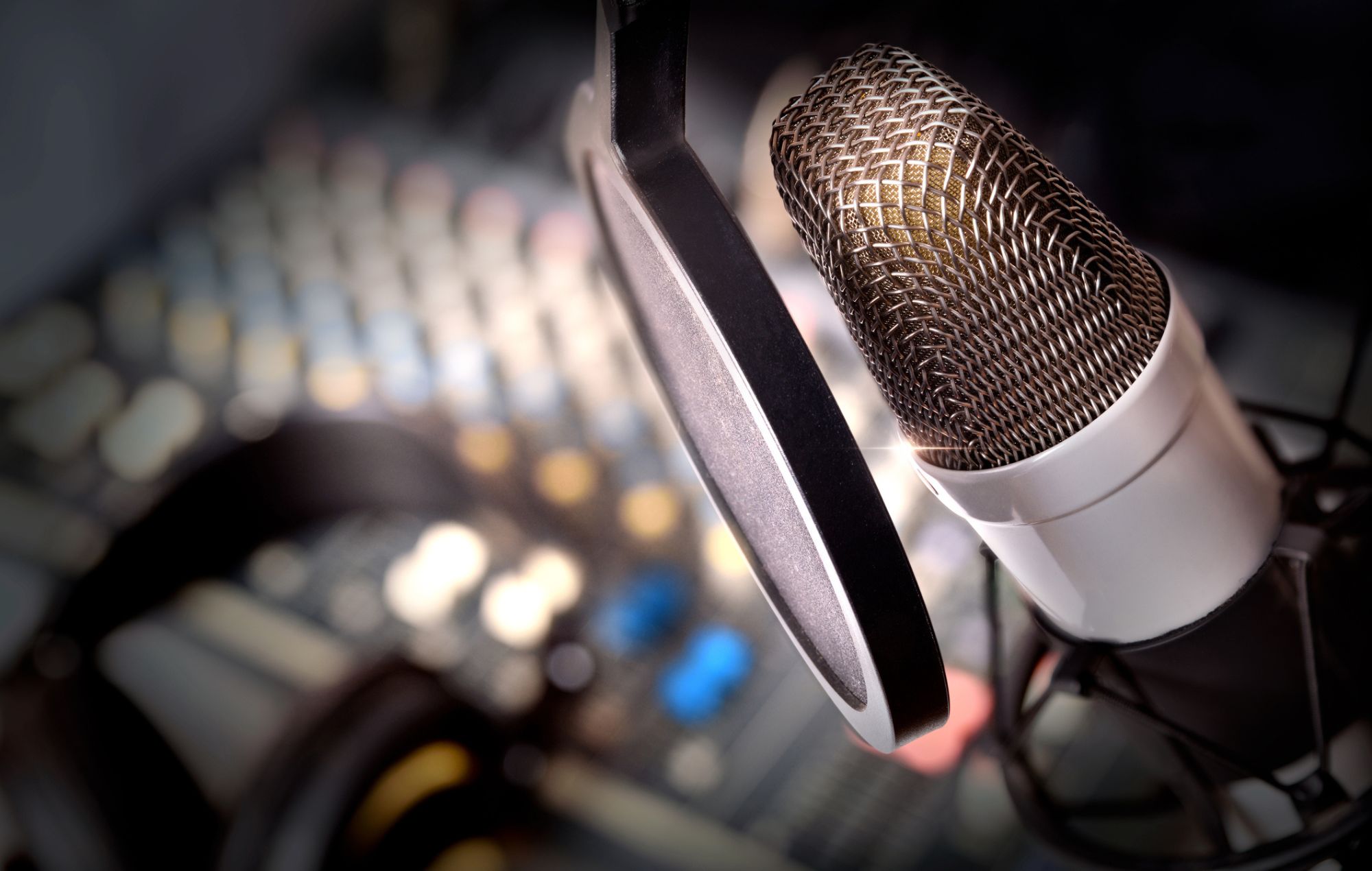 Recording equipment in studio. Studio microphone with headphones and mixer background. Elevated view